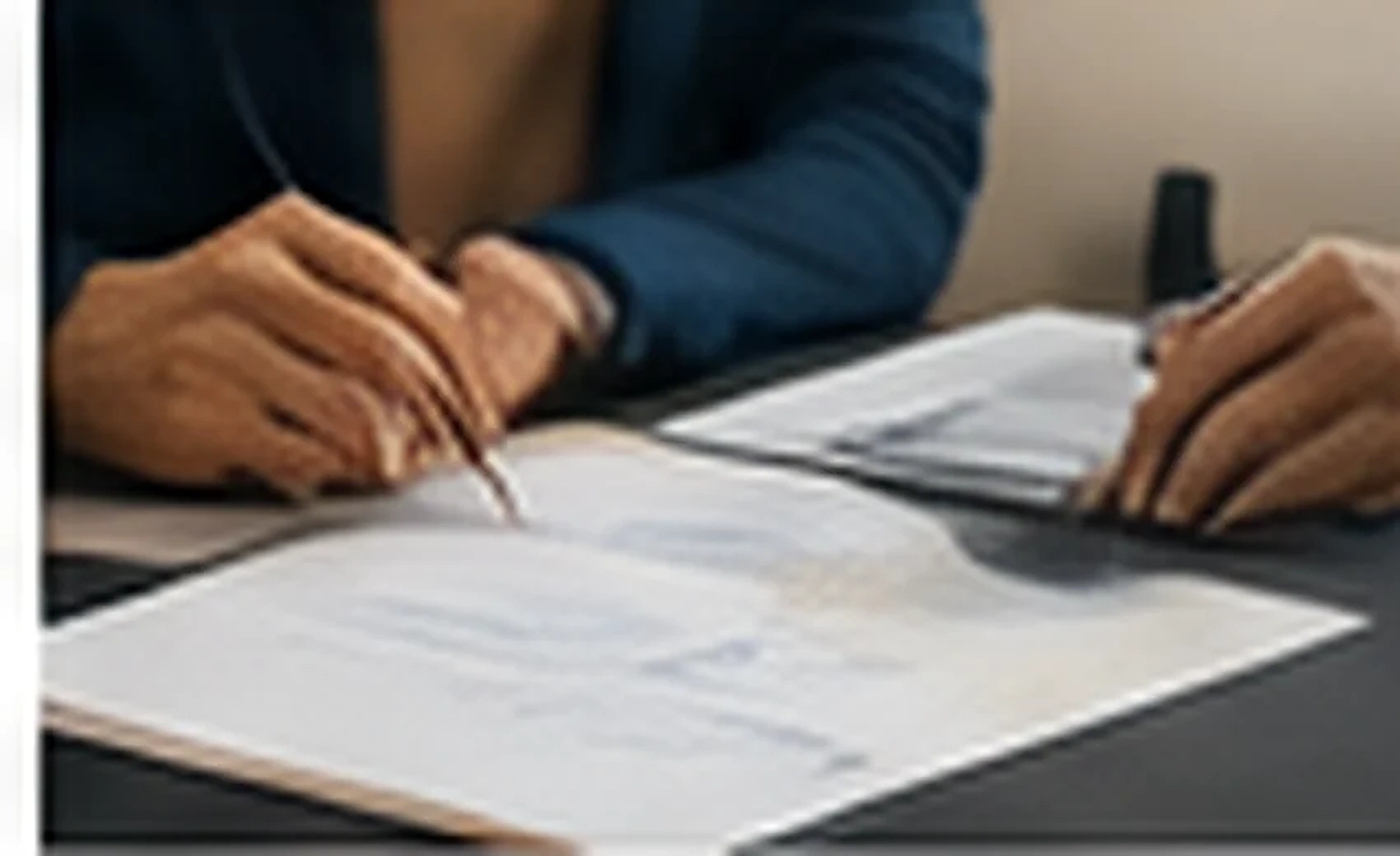 Hands reviewing documents during a professional business meeting